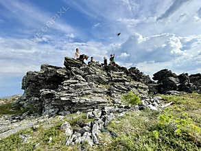Dyatlov pass, Northern Ural, Russia, July, 08, 2021.Tourists are on the big stone on Dyatlov pass in the summer. Northern Ural
