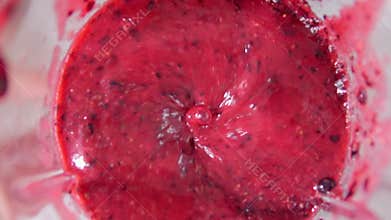 Berries are ground in a blender close-up. Black currant, preparation of a berry cocktail. Slow motion
