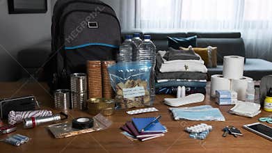 Emergency backpack equipment organized on the table