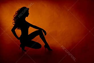 Woman silhouette over orange background