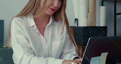 Beautiful happy successful 30s blonde entrepreneur business woman working online at modern office table using laptop.
