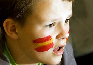 Spanish flag on face of boy
