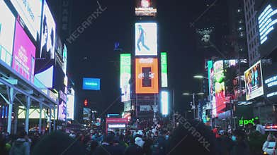 NEW YORK CITY, USA - 19.03,2021: Tourists People Walk in Famous Times Square in New York City Night. Popular tourist