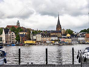 Sail boats in the port of Flensburg, St. Jorgen`s Church in the background. Schleswig-Holstein in Germany