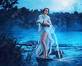Fantasy woman Greek goddess zodiac sign Aquarius holds vintage earthenware jug in her hands and pours water into river