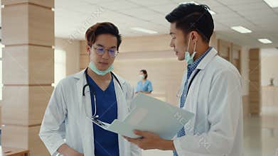 Asian doctors talk and discuss about patient`s case in hospital. Asia men medical practitioner consult patient case,