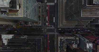 Aerial birds eye overhead top down view of cars driving in streets of downtown. Fly above high rise buildings. Manhattan