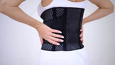 woman wearing back support belt isolated on white