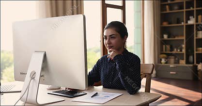 Indian woman using computer analyze statistics, preparing financial report