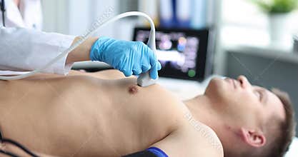 Doctor conducts medical examination of ultrasound of heart of man