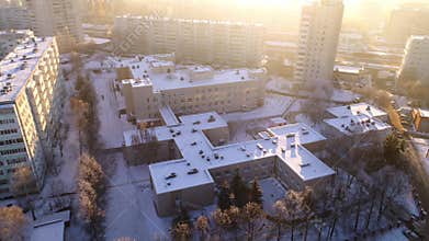 School and kindergarten buildings in city block in winter