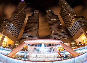 Tall Vertical Skyscrapers Surrounding Fountain of Wealth in Singapore at Night