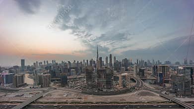 Panoramic skyline of Dubai with business bay and downtown district day to night timelapse.