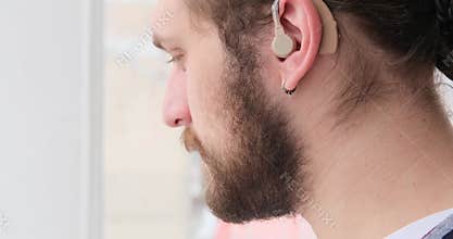 Man wearing hearing aid on ear