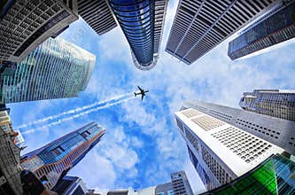 Plane Flying Over Tall Vertical Skyscrapers in Singapore Through Fisheye Lens