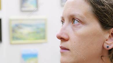 A girl in an art gallery. Looking at pictures