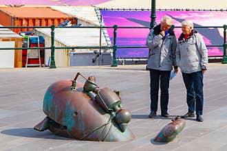 Couple of senior walking and intriguingly looking at a sculpture