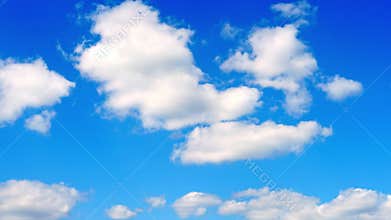 Beautiful white fluffy clouds slowly float against the blue sky on a warm sunny summer day. Timelapse video of cloud movement