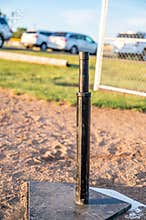 Tee ball stand at home plate used for youth baseball.