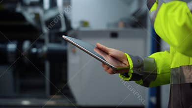 Closeup hands holding tablet computer at modern huge special facility storage.