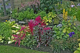 A small water feature in a decorative flower border