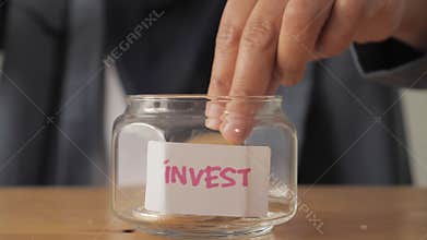 A person put bitcoin coin cryptocurrency in jar, digital asset investment