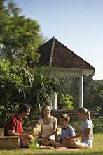 Family having picnic in park.