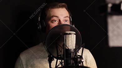 A professional announcer makes a recording in the studio