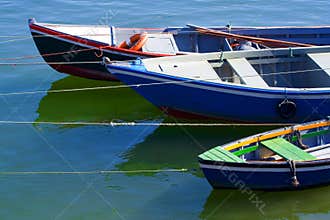 Fishing boats anchored over a clean water surface