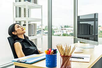 Serious stressed business woman sitting sad and thinking hard how to solve problem in office  company bankruptcy