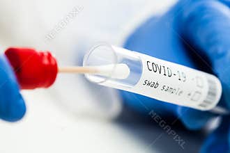 rt-PCR COVID-19 virus disease diagnostic test,UK lab technician wearing blue protective glove holding test tube with swabbing