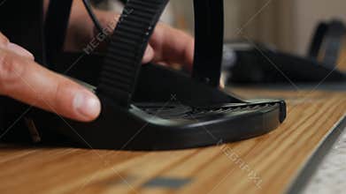 The man`s hand attaches the bindings to the snowboard. Prepares the snowboard for winter