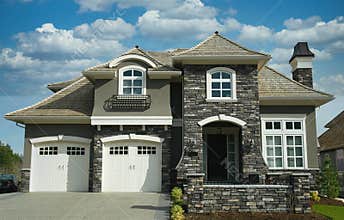 Designer Luxury Home House Maison Rock Stucco Front Exterior Cumulus Clouds Sky Background