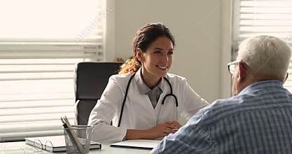 Female therapist talks to older patient fill medical history form