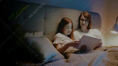 Mother and Daughter Watch Funny Movie on Tablet