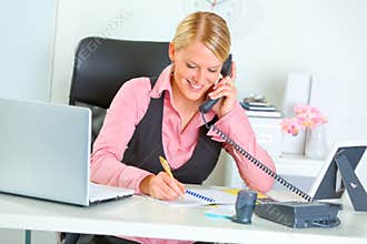 Smiling business woman talking phone
