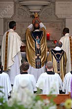 Priest consecrating wine at mass