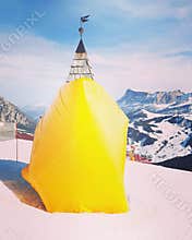 Yellow tent on ski slope