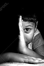 Dramatic look of a child. Portrait of a child. The golden eye looking at the future.