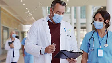 Doctor discussing medical report with nurse
