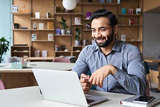 Smiling indian latin manager talking to employees virtual video meeting call.