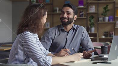 Two happy friendly diverse professional employees having discussion at work.