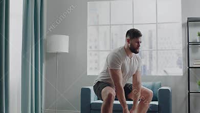 Strong athlete man squats with heavy cast iron weight