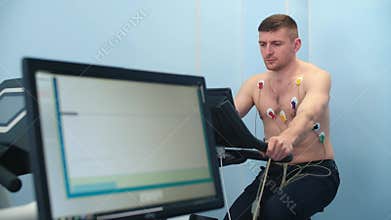An athlete doing a cardiac stress test using a medical bike.