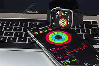 An iPhone and an Apple Watch with the Fitness app