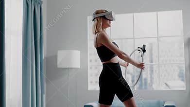 Pretty woman raises knees training with VR goggles at home