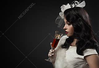 Graceful woman holding glass of wine