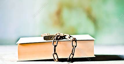 A book closed by a chain and a lock