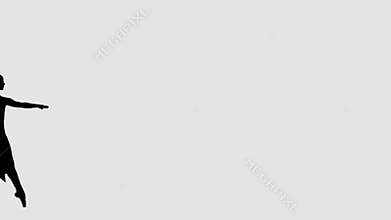 Silhouette of elegant ballerina dancing classical ballet.