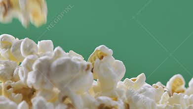Fresh popcorn falls on top of a pile Isolated on ChromaKey Background